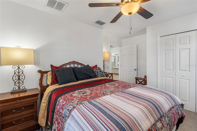 carpeted bedroom featuring visible vents, a closet, and ceiling fan