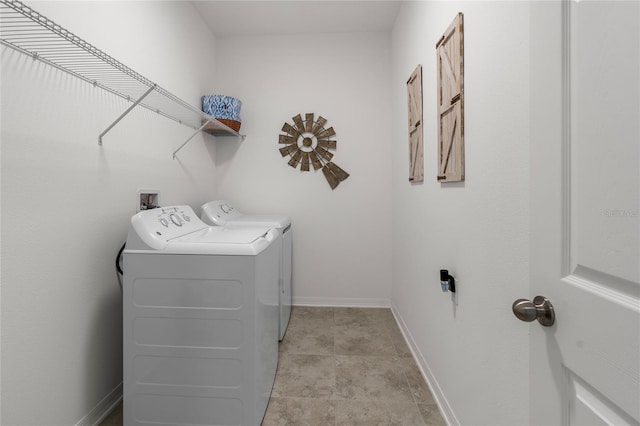 clothes washing area featuring independent washer and dryer, laundry area, and baseboards