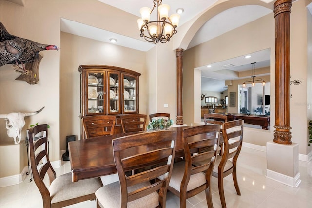 dining space with light tile patterned flooring, arched walkways, recessed lighting, and decorative columns