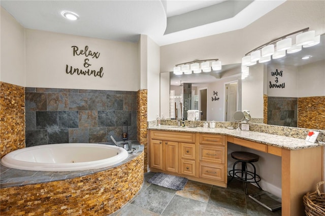 bathroom with a whirlpool tub and vanity