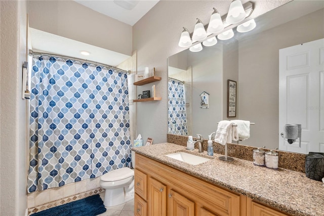 bathroom with curtained shower, tile patterned floors, vanity, and toilet