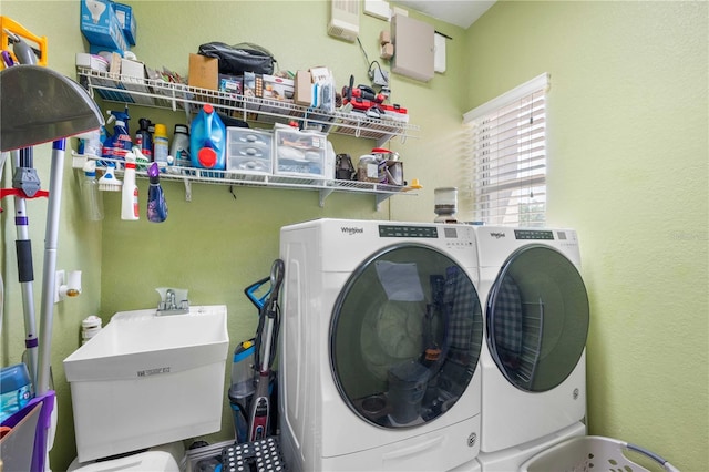 laundry room featuring separate washer and dryer, a sink, and laundry area