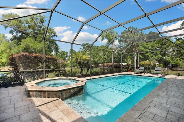 view of pool featuring a lanai, a patio area, and a pool with connected hot tub