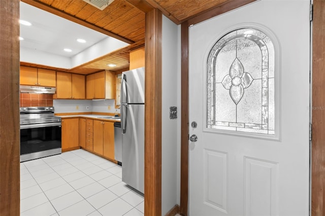 407 Indiana Ave, Crystal Beach, FL 34681 - kitchen featuring light tile patterned floors, light countertops, under cabinet range hood, recessed lighting, and stainless steel appliances