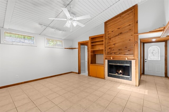 407 Indiana Ave, Crystal Beach, FL 34681 - unfurnished living room featuring baseboards, ceiling fan, a tile fireplace, wood ceiling, and vaulted ceiling with beams