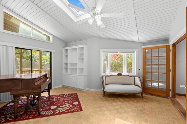 407 Indiana Ave, Crystal Beach, FL 34681 - sitting room featuring plenty of natural light, vaulted ceiling with skylight, and baseboards