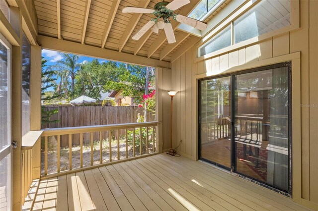 407 Indiana Ave, Crystal Beach, FL 34681 - unfurnished sunroom featuring beamed ceiling, hardwood / wood-style flooring, a ceiling fan, and a wooden deck