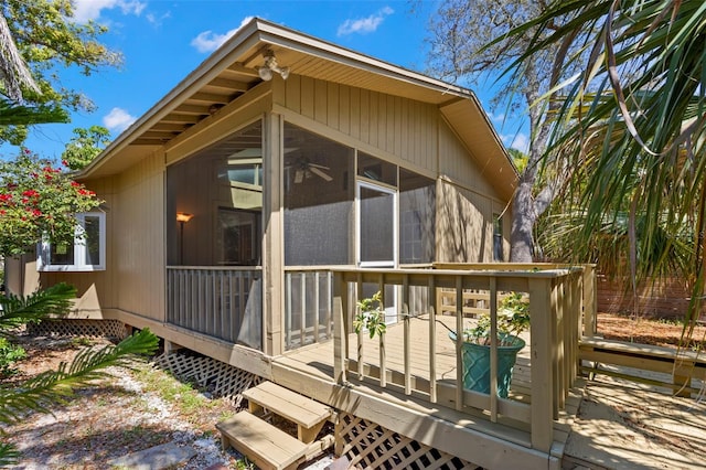 407 Indiana Ave, Crystal Beach, FL 34681 - view of property exterior with a sunroom and a wooden deck