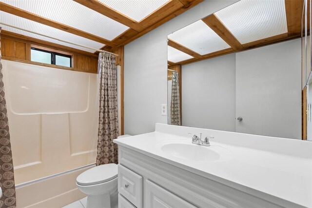 407 Indiana Ave, Crystal Beach, FL 34681 - bathroom featuring shower / bath combo, tile patterned floors, toilet, and vanity