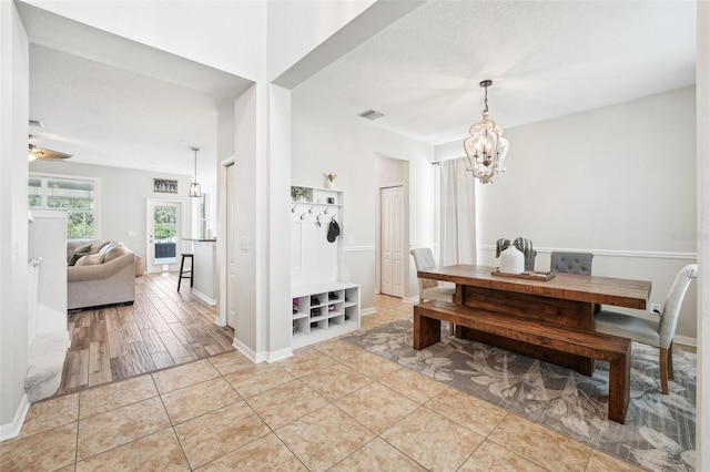 7207 Forest Mere Dr, Riverview, FL 33578 - dining space featuring a chandelier, light tile patterned flooring, and baseboards