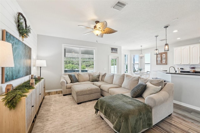7207 Forest Mere Dr, Riverview, FL 33578 - living area featuring light wood finished floors, ceiling fan, baseboards, and recessed lighting