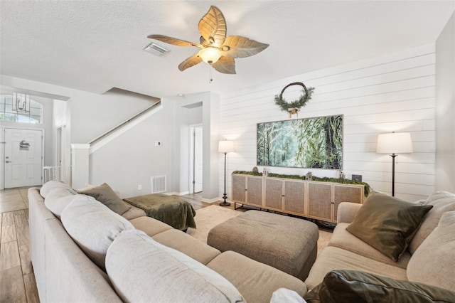 7207 Forest Mere Dr, Riverview, FL 33578 - living area featuring a ceiling fan, light wood-style flooring, and a textured ceiling
