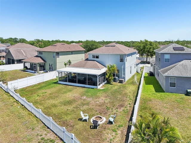 7207 Forest Mere Dr, Riverview, FL 33578 - rear view of house with a residential view, a sunroom, an outdoor fire pit, and cooling unit