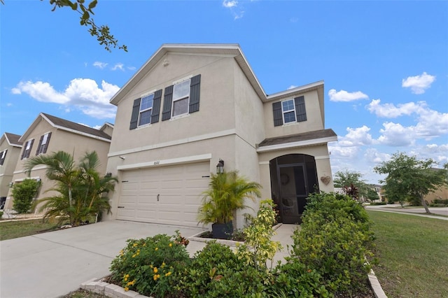 10101 Mangrove Well Rd, Ruskin, FL 33573 - traditional-style house featuring an attached garage, driveway, and stucco siding