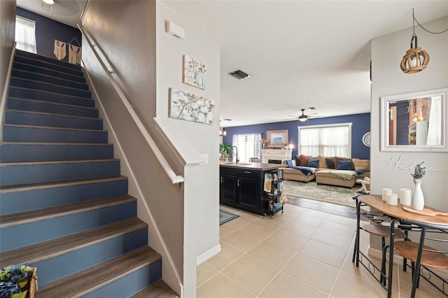10101 Mangrove Well Rd, Ruskin, FL 33573 - staircase with tile patterned floors, a ceiling fan, and visible vents