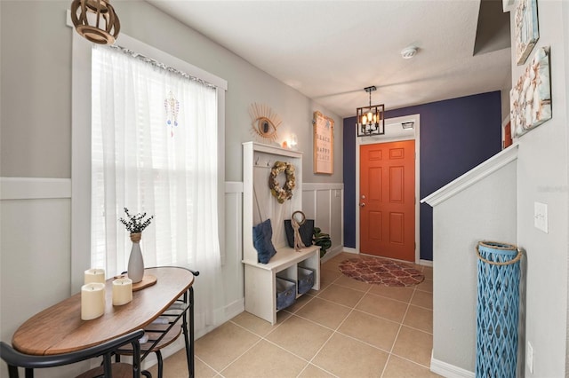 10101 Mangrove Well Rd, Ruskin, FL 33573 - foyer entrance with light tile patterned floors and an inviting chandelier