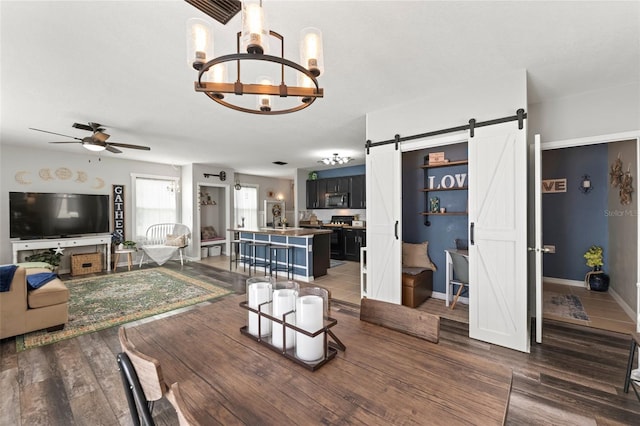 10101 Mangrove Well Rd, Ruskin, FL 33573 - living area featuring ceiling fan with notable chandelier, dark wood-style flooring, baseboards, and a barn door