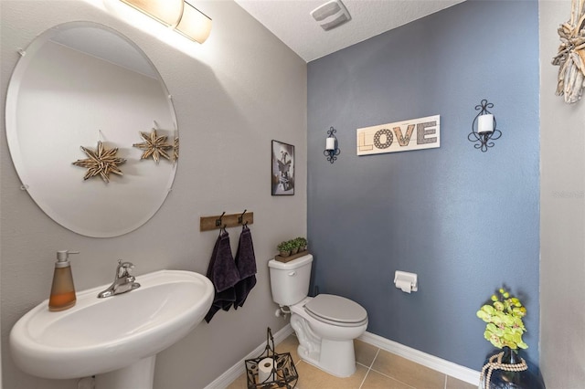10101 Mangrove Well Rd, Ruskin, FL 33573 - bathroom with a sink, tile patterned floors, baseboards, and toilet