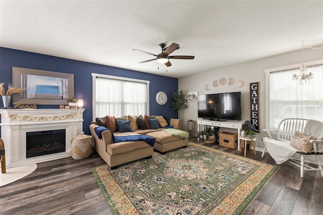 10101 Mangrove Well Rd, Ruskin, FL 33573 - living room with ceiling fan with notable chandelier, a textured ceiling, and wood finished floors