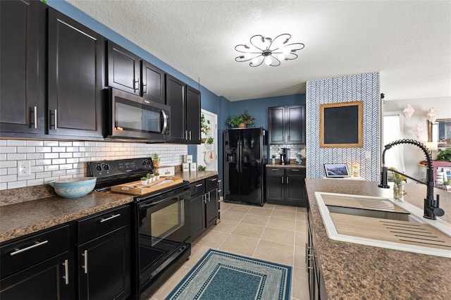 10101 Mangrove Well Rd, Ruskin, FL 33573 - kitchen featuring black appliances, light tile patterned flooring, a sink, dark countertops, and dark cabinetry