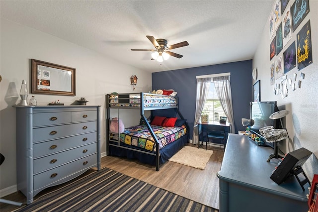 10101 Mangrove Well Rd, Ruskin, FL 33573 - bedroom with baseboards, a ceiling fan, wood finished floors, and a textured ceiling