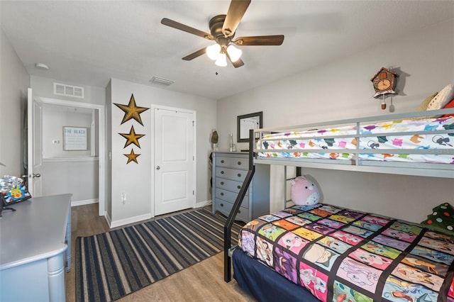10101 Mangrove Well Rd, Ruskin, FL 33573 - bedroom with wood finished floors, baseboards, and visible vents