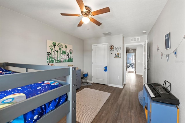 10101 Mangrove Well Rd, Ruskin, FL 33573 - bedroom featuring visible vents, baseboards, ceiling fan, and wood finished floors