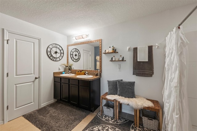 10101 Mangrove Well Rd, Ruskin, FL 33573 - bathroom featuring tile patterned floors, vanity, a textured ceiling, and a shower with curtain