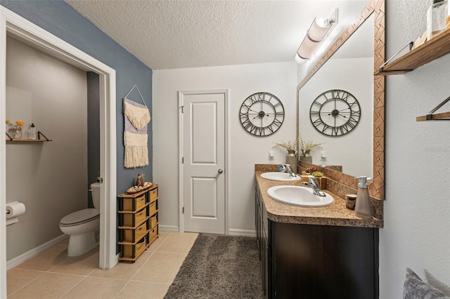10101 Mangrove Well Rd, Ruskin, FL 33573 - bathroom with a sink, toilet, tile patterned flooring, and a textured ceiling