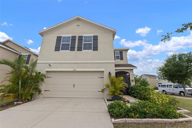 10101 Mangrove Well Rd, Ruskin, FL 33573 - traditional home featuring a garage, stucco siding, and concrete driveway