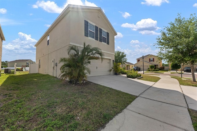 10101 Mangrove Well Rd, Ruskin, FL 33573 - view of home's exterior with concrete driveway, stucco siding, cooling unit, an attached garage, and a lawn