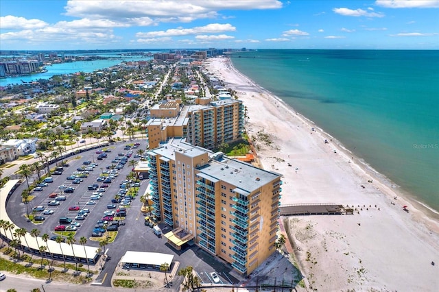 birds eye view of property featuring a water view, a city view, and a beach view