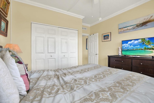 bedroom with a closet, ornamental molding, and visible vents