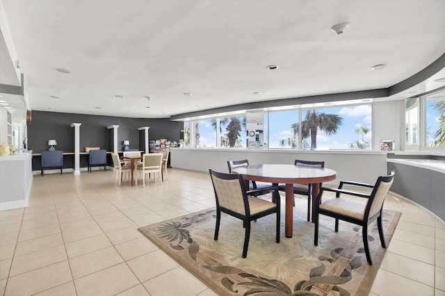 dining area featuring light tile patterned floors, baseboards, and a healthy amount of sunlight