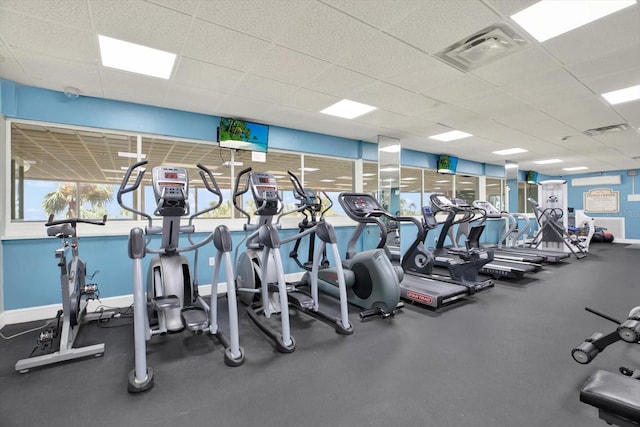gym featuring visible vents, baseboards, and a paneled ceiling