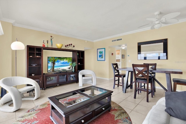 living area featuring crown molding, ceiling fan, visible vents, light tile patterned flooring, and baseboards