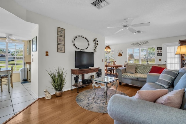 4819 Boonesboro Ct, New Port Richey, FL 34655 - living room with visible vents, ceiling fan, wood finished floors, and baseboards