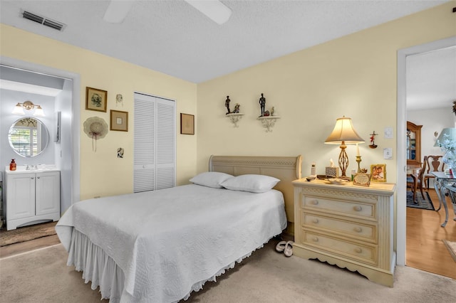 4819 Boonesboro Ct, New Port Richey, FL 34655 - bedroom featuring ceiling fan, a closet, light colored carpet, visible vents, and a sink