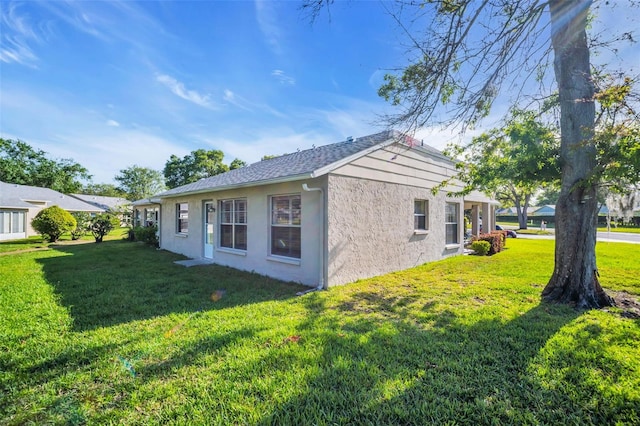 4819 Boonesboro Ct, New Port Richey, FL 34655 - view of side of home featuring a yard and stucco siding
