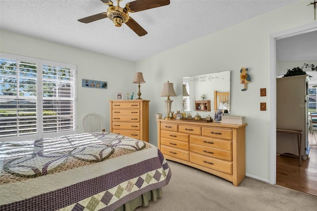 4819 Boonesboro Ct, New Port Richey, FL 34655 - bedroom with baseboards, a ceiling fan, light colored carpet, and a textured ceiling