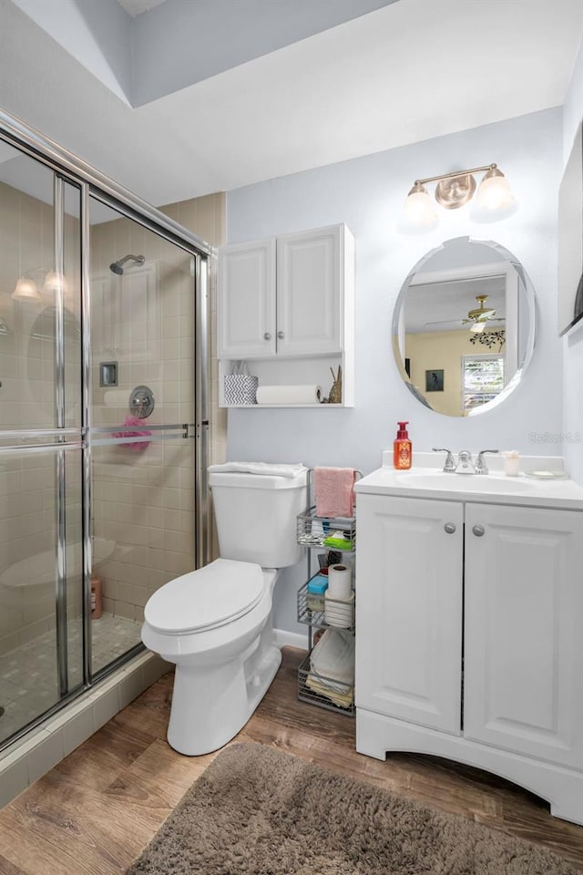 4819 Boonesboro Ct, New Port Richey, FL 34655 - full bathroom with toilet, a stall shower, wood finished floors, and vanity