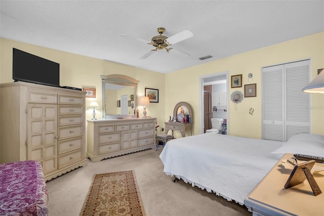 4819 Boonesboro Ct, New Port Richey, FL 34655 - bedroom with visible vents, a closet, a ceiling fan, ensuite bath, and light carpet