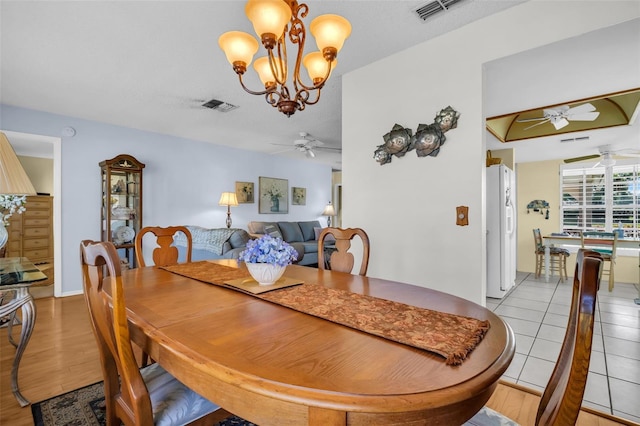 4819 Boonesboro Ct, New Port Richey, FL 34655 - dining room with visible vents, light tile patterned floors, and ceiling fan with notable chandelier