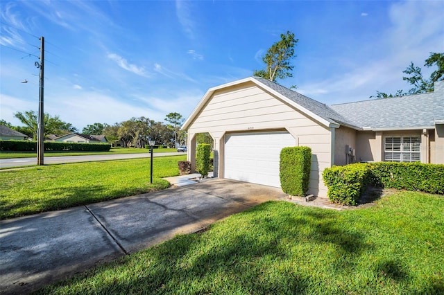4819 Boonesboro Ct, New Port Richey, FL 34655 - view of side of home with concrete driveway, stucco siding, an attached garage, a yard, and a shingled roof