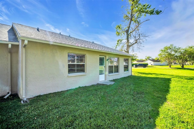 4819 Boonesboro Ct, New Port Richey, FL 34655 - rear view of house featuring a yard and stucco siding