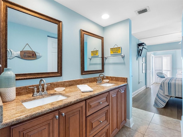 19925 Gulf Blvd Unit 402, Indian Shores, FL 33785 - bathroom with baseboards, double vanity, a sink, and visible vents