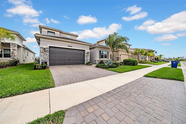 3096 Great Banyan Way, Wesley Chapel, FL 33543 - view of front of home with stone siding, decorative driveway, a front yard, stucco siding, and an attached garage