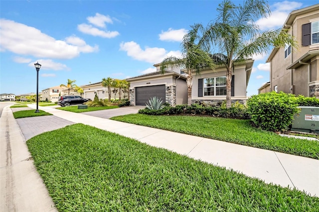 3096 Great Banyan Way, Wesley Chapel, FL 33543 - view of front facade with stone siding, concrete driveway, an attached garage, stucco siding, and a front yard