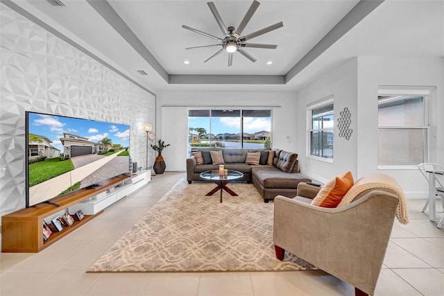 3096 Great Banyan Way, Wesley Chapel, FL 33543 - tiled living room with ceiling fan, a raised ceiling, baseboards, and recessed lighting