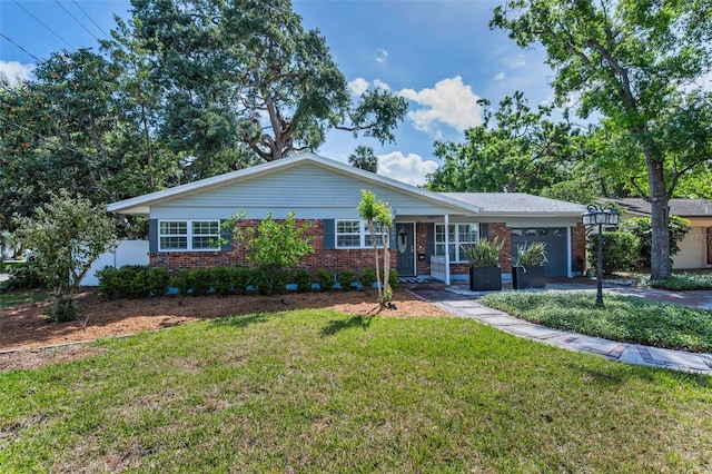 202 S Hesperides St, Tampa, FL 33609 - ranch-style home with brick siding, an attached garage, and driveway